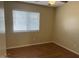 Bedroom featuring a window for natural light and wood-look laminate flooring at 14228 N 150Th Ln, Surprise, AZ 85379