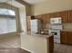 Functional kitchen featuring a center island with a sink and white appliances at 14228 N 150Th Ln, Surprise, AZ 85379