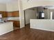 Open-concept kitchen featuring wood laminate flooring, an island, and white appliances at 14228 N 150Th Ln, Surprise, AZ 85379