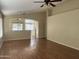 Open-concept living room featuring vaulted ceilings and durable laminate flooring at 14228 N 150Th Ln, Surprise, AZ 85379