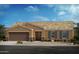 Charming single-story home with a two-car garage, desert landscaping, and a covered entryway at 1436 E Angie Dr, Casa Grande, AZ 85122
