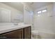 Well-lit bathroom features a bathtub, vanity, and matching fixtures at 1624 N 77Th Gln, Phoenix, AZ 85035