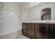 Clean bathroom with a tub-shower combination, tiled walls, and dual sink vanity at 1624 N 77Th Gln, Phoenix, AZ 85035