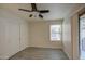 Bedroom with closet, gray wood-look floors, window with blinds, and access to the balcony at 1624 N 77Th Gln, Phoenix, AZ 85035