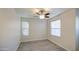 This bedroom features wood-look flooring, natural light, and a ceiling fan at 1624 N 77Th Gln, Phoenix, AZ 85035