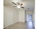 Light bedroom featuring wood-look flooring, ceiling fan, and sliding door to the backyard at 1624 N 77Th Gln, Phoenix, AZ 85035