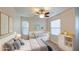 Cozy bedroom with a trundle bed, a ceiling fan, and a modern dresser with toys at 1624 N 77Th Gln, Phoenix, AZ 85035