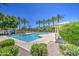 Community pool with palm trees and ample seating areas at 1624 N 77Th Gln, Phoenix, AZ 85035