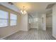 Dining area with lots of natural light, wood-look floors, chandelier, and staircase at 1624 N 77Th Gln, Phoenix, AZ 85035