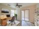 Bright home office with a modern desk, a sliding glass door, and built-in bookshelves at 1624 N 77Th Gln, Phoenix, AZ 85035