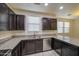 Spacious kitchen features stainless steel appliances, granite countertops, and ample cabinet space at 1624 N 77Th Gln, Phoenix, AZ 85035