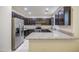 Modern kitchen with stainless steel appliances, granite countertops, and plenty of storage space at 1624 N 77Th Gln, Phoenix, AZ 85035