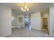 Bright living room with wood-look floors, chandelier, and access to other rooms in the home at 1624 N 77Th Gln, Phoenix, AZ 85035