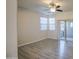 Well-lit living room featuring wood-look floors, large windows, and ceiling fan at 1624 N 77Th Gln, Phoenix, AZ 85035