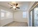 Open living room with ceiling fan and access to outdoor patio at 1624 N 77Th Gln, Phoenix, AZ 85035