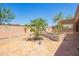 A private backyard retreat with a small water feature and covered patio at 18322 W Sweet Acacia Dr, Goodyear, AZ 85338