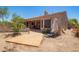 Spacious backyard with an extended covered patio and desert landscaping at 18322 W Sweet Acacia Dr, Goodyear, AZ 85338