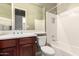 Bright bathroom featuring a white tiled shower and neutral toned walls at 18322 W Sweet Acacia Dr, Goodyear, AZ 85338