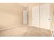 Bedroom with a closet featuring white doors, carpeted flooring, and neutral paint providing a serene space at 18322 W Sweet Acacia Dr, Goodyear, AZ 85338