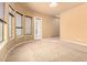 Bedroom featuring neutral carpet, large windows, and an adjacent balcony at 18322 W Sweet Acacia Dr, Goodyear, AZ 85338