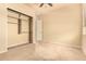 Comfortable bedroom featuring carpet, a closet with white doors and a window offering natural light at 18322 W Sweet Acacia Dr, Goodyear, AZ 85338