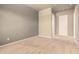 Bedroom with carpet, neutral colors, and an interior door to complement its inviting and calm interior at 18322 W Sweet Acacia Dr, Goodyear, AZ 85338