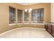 Bright dining area featuring large windows and a built-in serving station at 18322 W Sweet Acacia Dr, Goodyear, AZ 85338