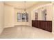 Open-concept dining room with tile flooring, chandelier lighting, and custom built-ins at 18322 W Sweet Acacia Dr, Goodyear, AZ 85338