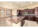 Spacious kitchen features a large island, dark wood cabinets, and stainless steel appliances at 18322 W Sweet Acacia Dr, Goodyear, AZ 85338