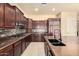 Well-appointed kitchen with dark wood cabinets, granite countertops, and modern appliances at 18322 W Sweet Acacia Dr, Goodyear, AZ 85338