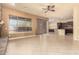 Open-concept living room with tile flooring, ceiling fan and a beautiful stone fireplace at 18322 W Sweet Acacia Dr, Goodyear, AZ 85338