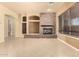 Open-concept living room with tile flooring, stone fireplace and view of adjacent spaces at 18322 W Sweet Acacia Dr, Goodyear, AZ 85338