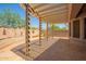 Covered patio with desert landscaping for outdoor living and dining at 18322 W Sweet Acacia Dr, Goodyear, AZ 85338