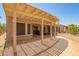 Covered patio with desert landscaping and room to relax and dine at 18322 W Sweet Acacia Dr, Goodyear, AZ 85338