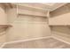 Spacious walk-in closet with built-in shelving and carpeted flooring for organized storage at 18322 W Sweet Acacia Dr, Goodyear, AZ 85338