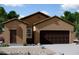 Charming single-story home with a well-maintained front yard and a two-car garage at 1959 E Bucking Bronco Dr, San Tan Valley, AZ 85140