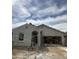 A house under construction is shown with scaffolding in front of the garage and entryway at 1973 E Bucking Bronco Dr, San Tan Valley, AZ 85140