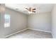 Neutral bedroom with a ceiling fan, tile flooring, and natural light at 20411 W Mountain Sage W Dr, Buckeye, AZ 85326