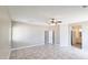This bedroom features a ceiling fan and tile flooring with a full bathroom nearby at 20411 W Mountain Sage W Dr, Buckeye, AZ 85326