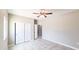 Bedroom with tile floors, closet doors, ceiling fan, and an ensuite bathroom entrance at 20411 W Mountain Sage W Dr, Buckeye, AZ 85326