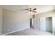 This bedroom features a ceiling fan, tile flooring, and large closet at 20411 W Mountain Sage W Dr, Buckeye, AZ 85326