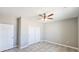 A clean and well-lit bedroom with double closets and a ceiling fan at 20411 W Mountain Sage W Dr, Buckeye, AZ 85326