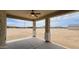 Covered patio with ceiling fan looking out onto a large lot at 20411 W Mountain Sage W Dr, Buckeye, AZ 85326