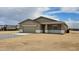 Single story home with a two-car garage and neutral-toned exterior in desert community at 20411 W Mountain Sage W Dr, Buckeye, AZ 85326