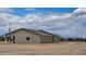 Exterior view of home with desert landscaping and a covered patio at 20411 W Mountain Sage W Dr, Buckeye, AZ 85326