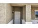Close-up view of the white front door featuring stucco columns at 20411 W Mountain Sage W Dr, Buckeye, AZ 85326