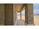 Covered front porch with columns and a view of desert landscape at 20411 W Mountain Sage W Dr, Buckeye, AZ 85326