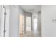 Hallway featuring tile flooring, multiple white doors, recessed lighting and a thermostat at 20411 W Mountain Sage W Dr, Buckeye, AZ 85326