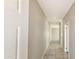 Long hallway featuring neutral paint, recessed lighting, and tile flooring at 20411 W Mountain Sage W Dr, Buckeye, AZ 85326