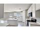 Bright kitchen features white cabinets, an island, and modern appliances at 20411 W Mountain Sage W Dr, Buckeye, AZ 85326